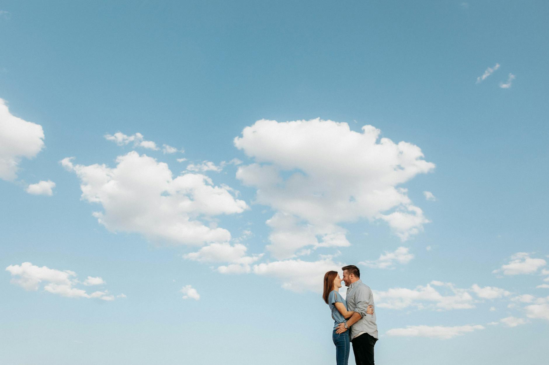 a couple kissing under the blue sky
